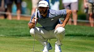 Mar 12, 2021; Ponte Vedra Beach, Florida, USA; Dustin Johnson lines up his putt on the seventh green during the second round of The Players Championship golf tournament at TPC Sawgrass - Stadium Course.